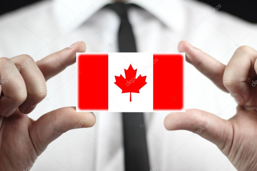 Businessman holding a business card with a Canada Flag