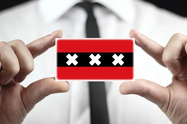 Businessman holding a business card with Amsterdam City Flag — Stock Photo, Image