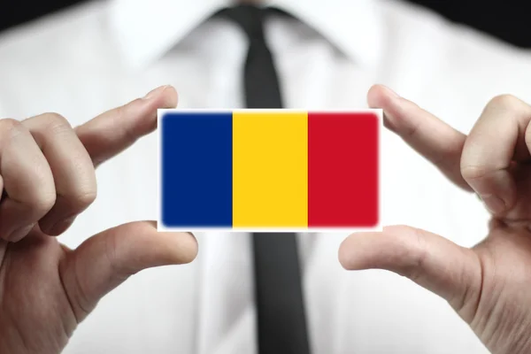 Businessman holding a business card with a Romania Flag — Stock Photo, Image