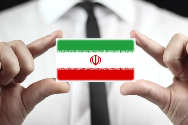 Zakenman houden een visitekaartje met iran vlag — Stockfoto