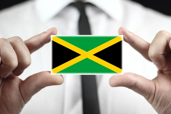 Businessman holding a business card with Jamaica Flag — Stock Photo, Image