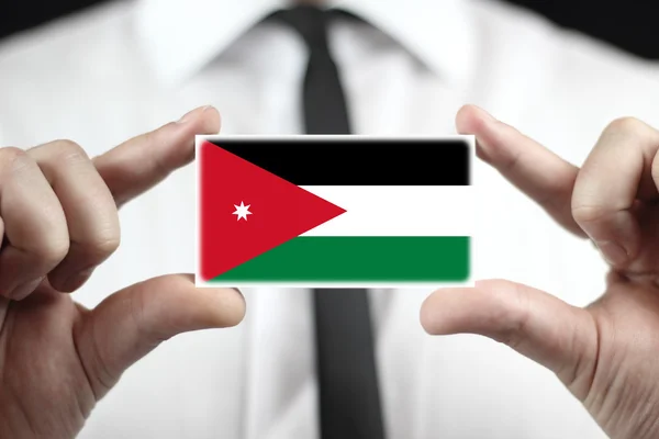 Biznesmen posiadania wizytówki z flaga Jordanii — Zdjęcie stockowe