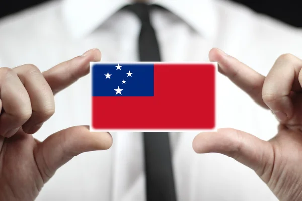 Businessman holding a business card with Samoa Flag — Stock Photo, Image