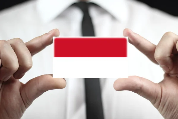 Businessman holding a business card with Indonesia Flag — Stock Photo, Image