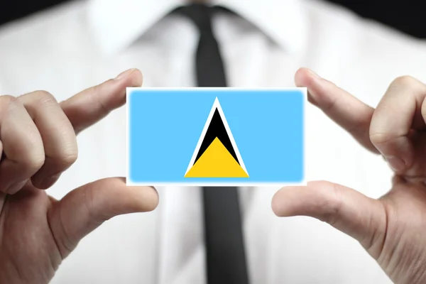 Zakenman houden een visitekaartje met vlag van saint lucia — Stockfoto