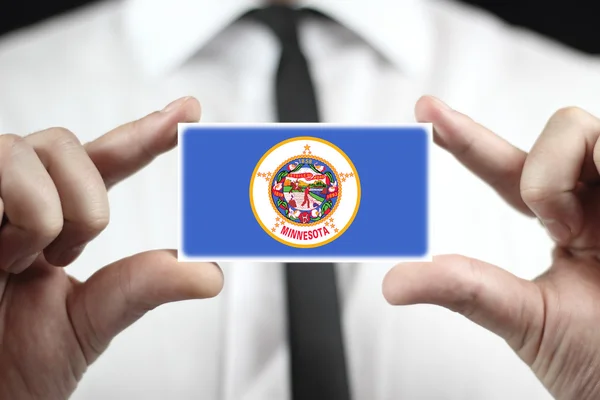 Businessman holding a business card with Minnesota State Flag — Stock Photo, Image