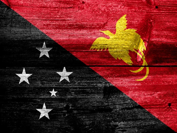 Papua New Guinea Flag painted on old wood plank texture — Stock Photo, Image