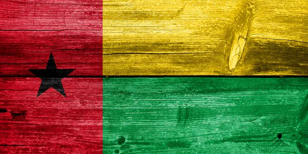 Guinea Bissau Flag painted on old wood plank texture — Stock Photo, Image