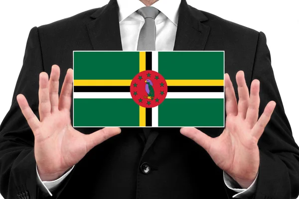 Empresário segurando um cartão de visita com bandeira Dominica — Fotografia de Stock