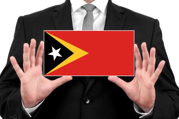 Affärsman som innehar ett visitkort med east timor flagga — Stockfoto