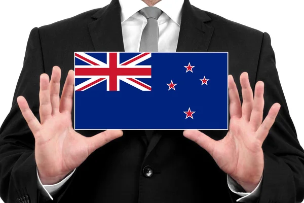 Businessman holding a business card with New Zealand Flag — Stock Photo, Image