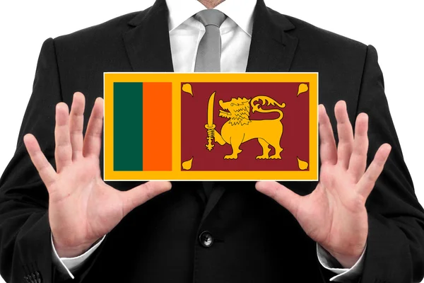Бизнесмен с визитной карточкой под флагом Шри-Ланки — стоковое фото