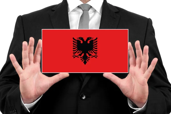 Empresario con una tarjeta de visita con Bandera de Albania — Foto de Stock