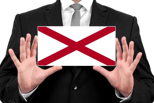 Бизнесмен, держащий визитку с флагом штата Алабама — стоковое фото
