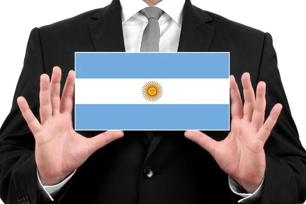 Geschäftsmann mit Visitenkarte mit argentinischer Flagge — Stockfoto