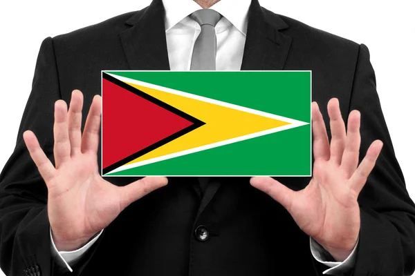 Businessman holding a business card with Guyana Flag — Stock Photo, Image