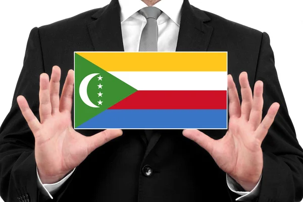 Homme d'affaires titulaire d'une carte de visite avec drapeau des Comores — Photo