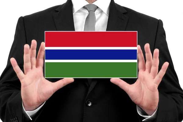 Podnikatel drží vizitku s Gambijská vlajka — Stock fotografie