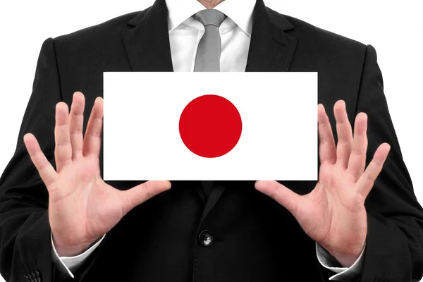 Podnikatel drží vizitku s Japonskem vlajky — Stock fotografie