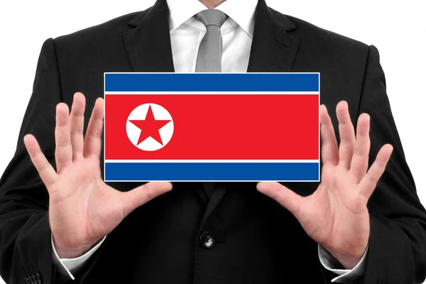 Kuzey Kore bayrağı ile kartvizit tutan işadamı — Stok fotoğraf