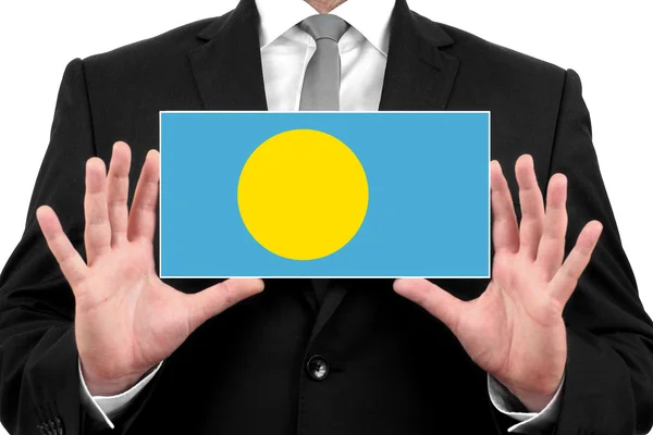 Businessman holding a business card with Palau Flag — Stock Photo, Image