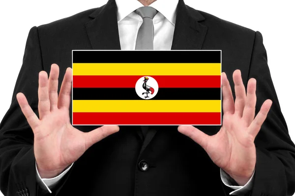 Businessman holding a business card with Uganda Flag — Stock Photo, Image