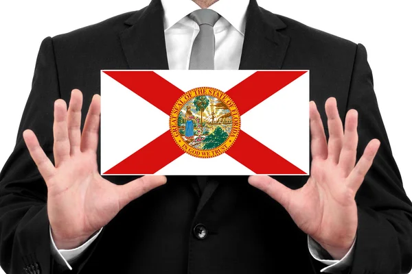 Homme d'affaires détenant une carte de visite avec le drapeau de l'État de Floride — Photo