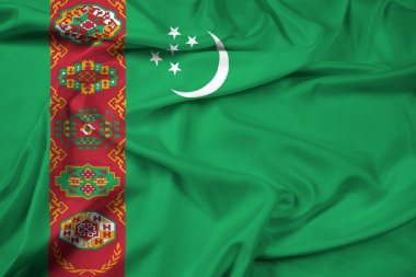 Türkmenistan bayrağı sallayarak