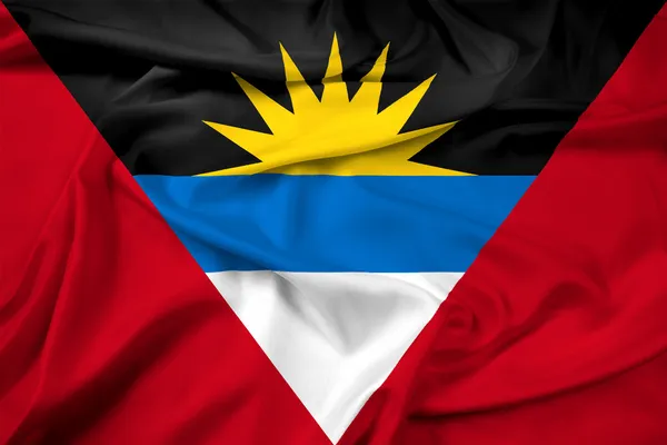Размахивая флагом Антигуа и Барбуды — стоковое фото
