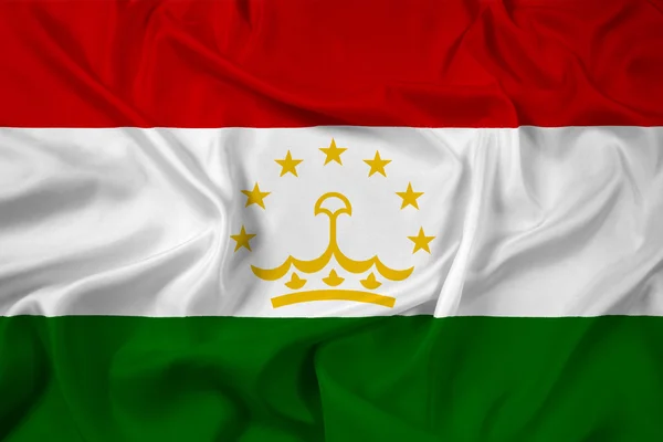 Tacikistan bayrağı sallayarak — Stok fotoğraf