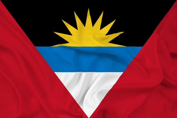 Размахивая флагом Антигуа и Барбуды — стоковое фото