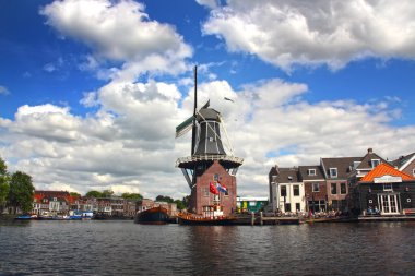 Scenic Dutch Windmill By The River In Haarlem, The Netherlands clipart