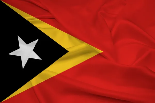 Doğu timor bayrağı sallayarak — Stok fotoğraf