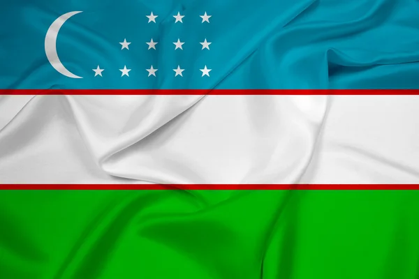 Ondeando la bandera de Uzbekistán — Foto de Stock