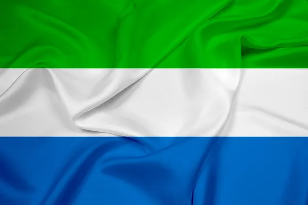 Macha flagą sierra leone — Zdjęcie stockowe