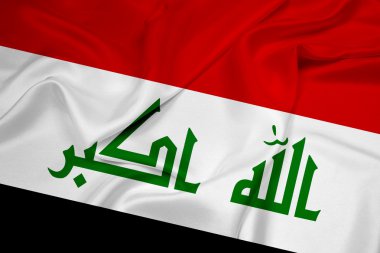 Irak bayrağı sallayarak