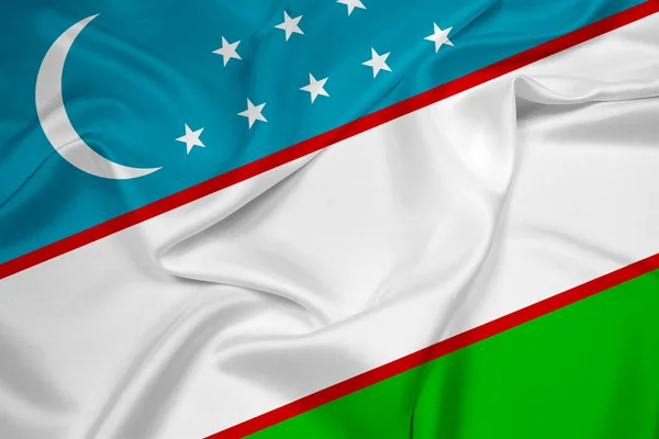 Viftar uzbekistan flagga — Stockfoto