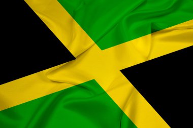 Jamaika bayrağını sallıyor