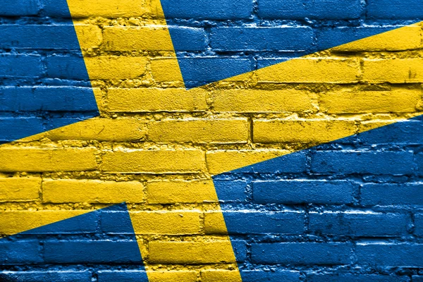 Sverige flagga målade på tegelvägg — Stockfoto