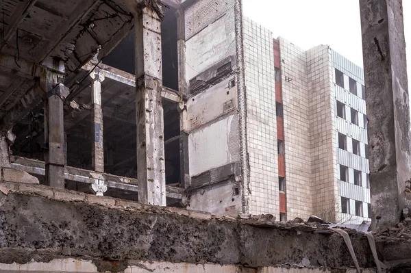 Marco de vigas de hormigón y montones de un gran edificio destruido de cerca. Contexto —  Fotos de Stock