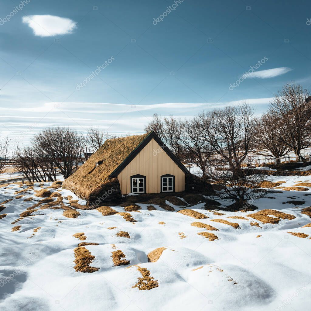 Hofskirkja Church, Hof, Iceland in winter with snow and blue sky. This fairytale-like building is the last turf church ever built in Iceland. this traditional wood and stone structure was built in