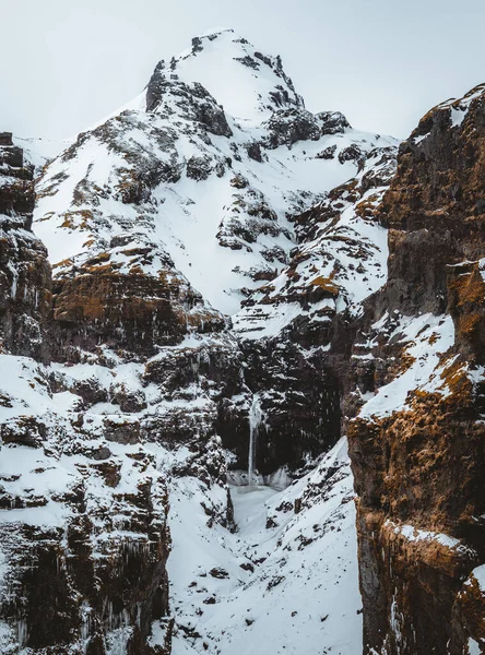 Secret canyon named Mulagljufur canyon in South Iceland. Waterfall below mountain top in winter and snow landscape. Top tourism destination. South East of Iceland, Europe — Stock Photo, Image