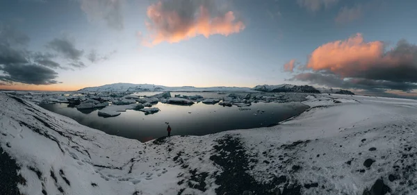 Aerial drone panorama of famous lake Joekulsarlon glacial lagoon and diamond beach with its icebergs and ice floes in Iceland during sunset twilight in winter. — Stock Photo, Image