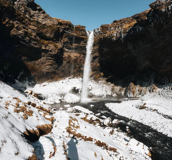 View from flying drone of Kvernufoss waterfall. Amazing winterscene with snow and river in Iceland, Europe. Beauty of nature concept background. — Zdjęcie stockowe