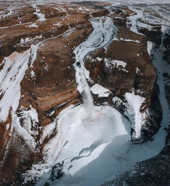 Aerial drone view of Haifoss waterfall in Iceland during Winter in the Highlands. Blue sky and clouds in snow. — стокове фото