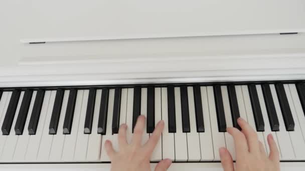 View from above. female hands close up. woman musician plays the piano — Wideo stockowe