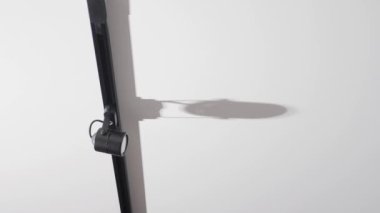 Ceiling black spotlights on a rail system on a white ceiling background