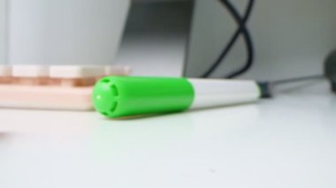 detailed extreme close-up, multi-colored markers, computer keyboard and audio card on a desk