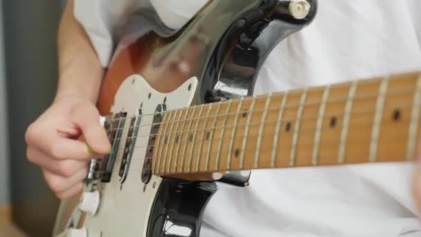 Closeup of male hands with a plectrum playing the electric guitar — 图库视频影像
