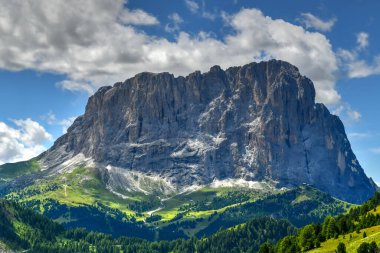 Colors of the Dolomites in the Funes view of the valley in Southern Tyrol, Italy. Green grass, mountains and blue sky. Summer.